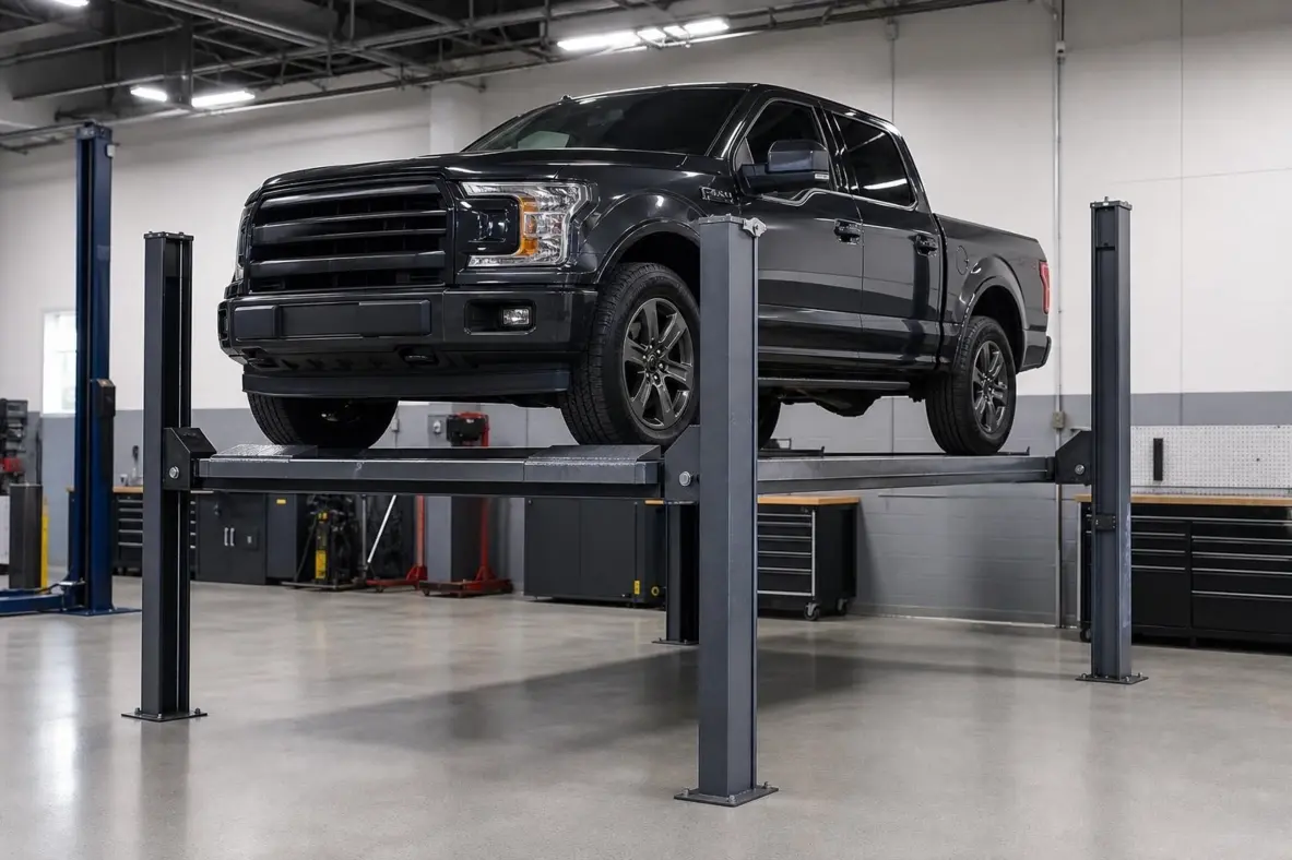 4-post drive-on car lift holding a pickup truck for service in a shop