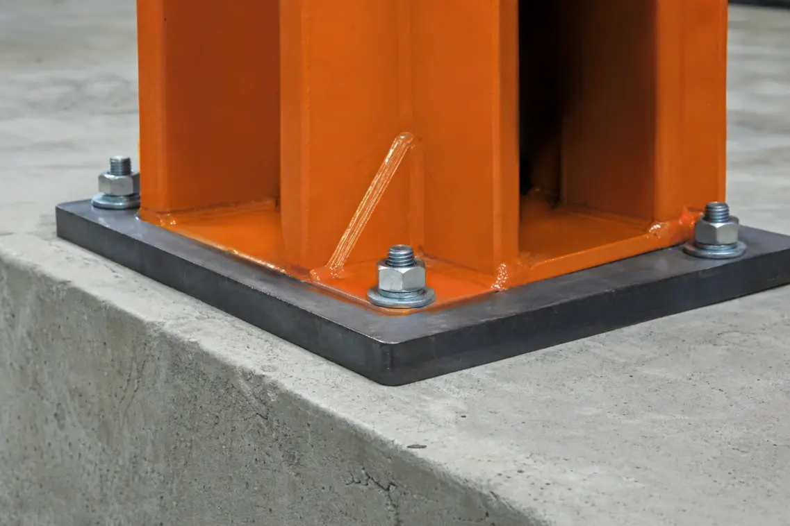 Anchor bolt secured through a lift base plate into reinforced concrete