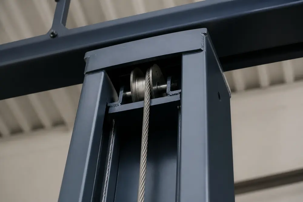 Equalizer cable seated in the top sheave during 2 post lift installation